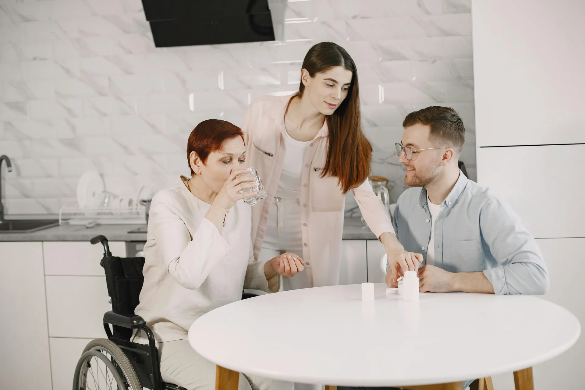 A family supporting an elderly woman at home